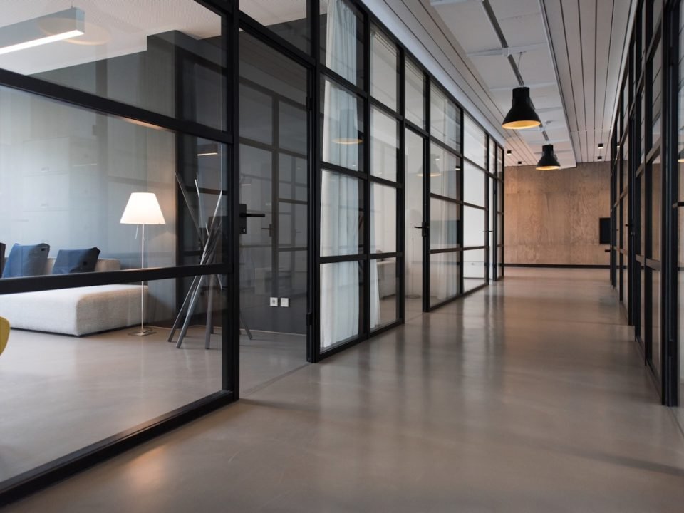 Contemporary corporate office with glass, stone and warm lighting